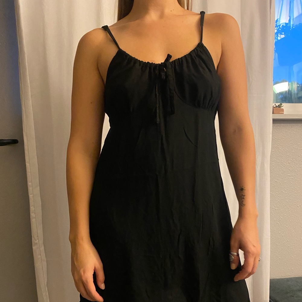 Black cotton on dress, adjustable straps with a tie in front, loose fit